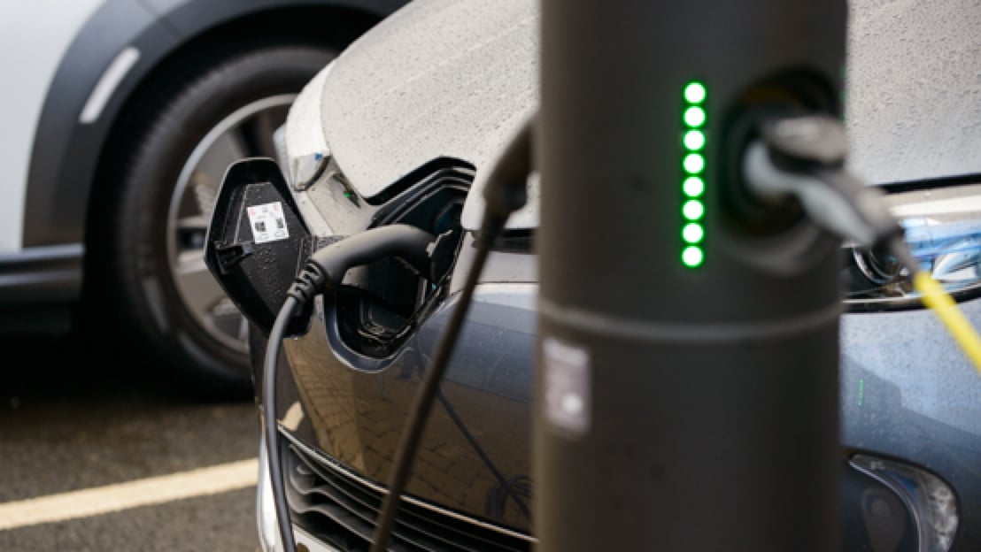 Electric car parked next to charge port