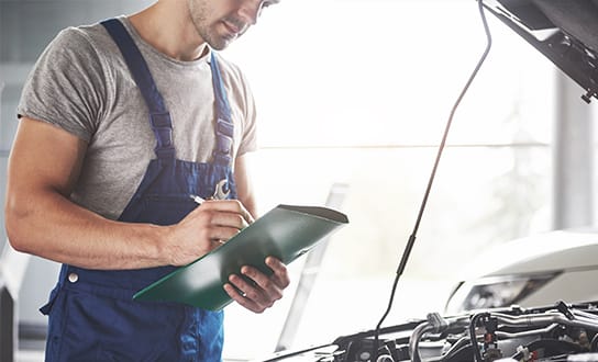 Mechanic inspecting car