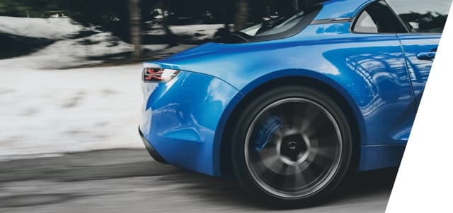 Alpine A110 on a gravel road