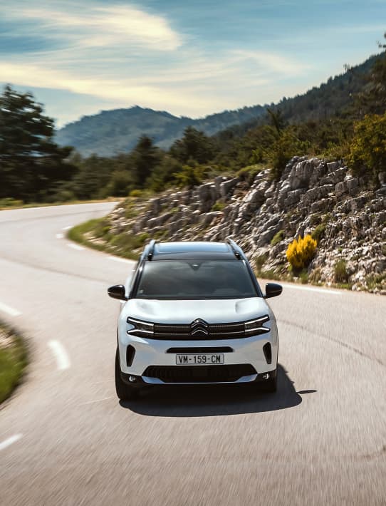 White Citroën C3 Aircross driving down a hill